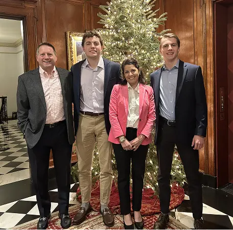 Craig Sumerel with family in front of a Christmas tree. 